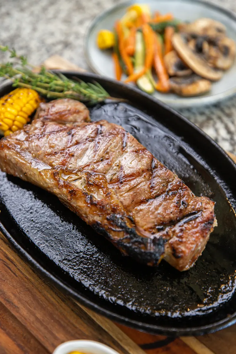 New York strip steak on cast iron platter